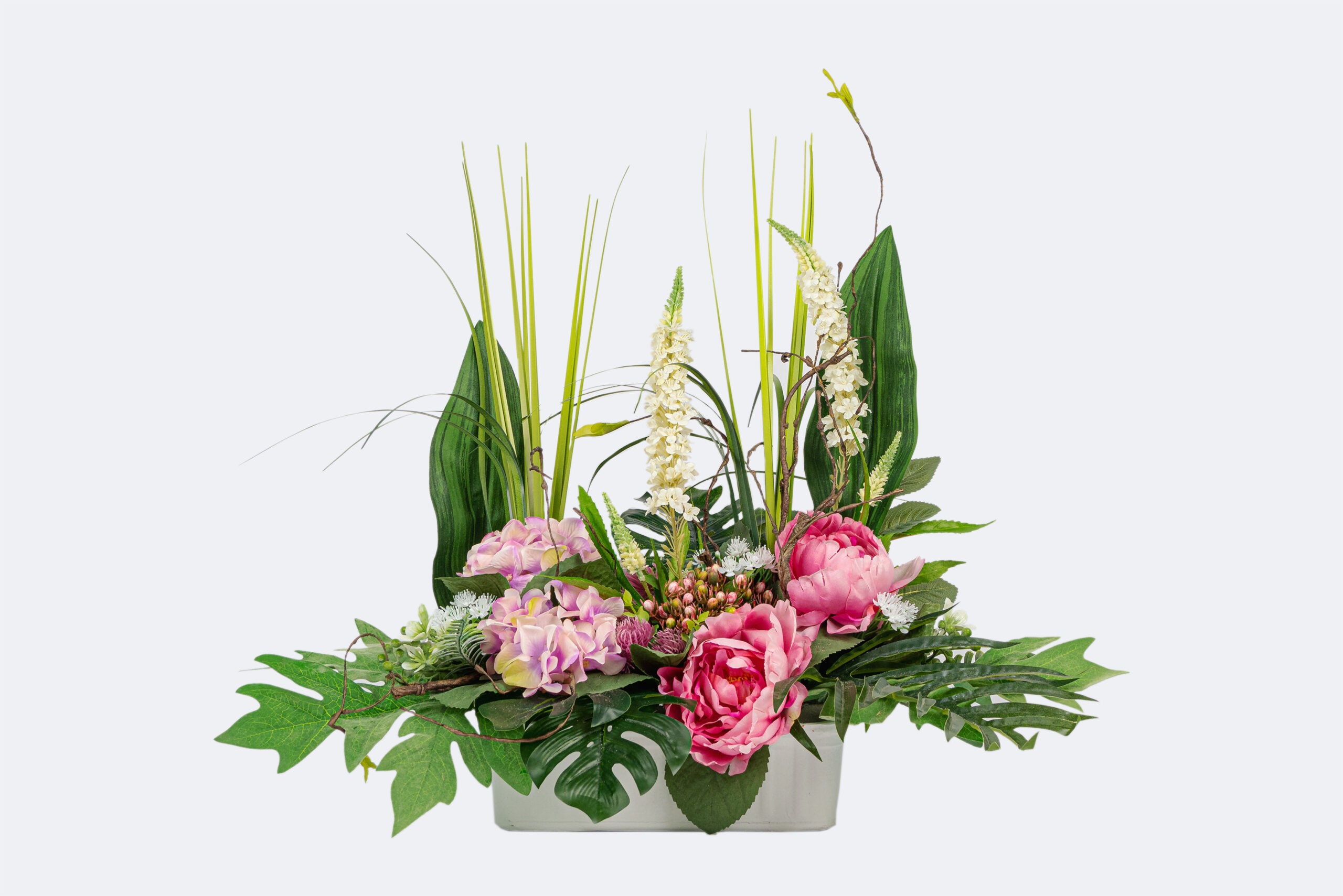 Jardinera artificial de tons rosats.