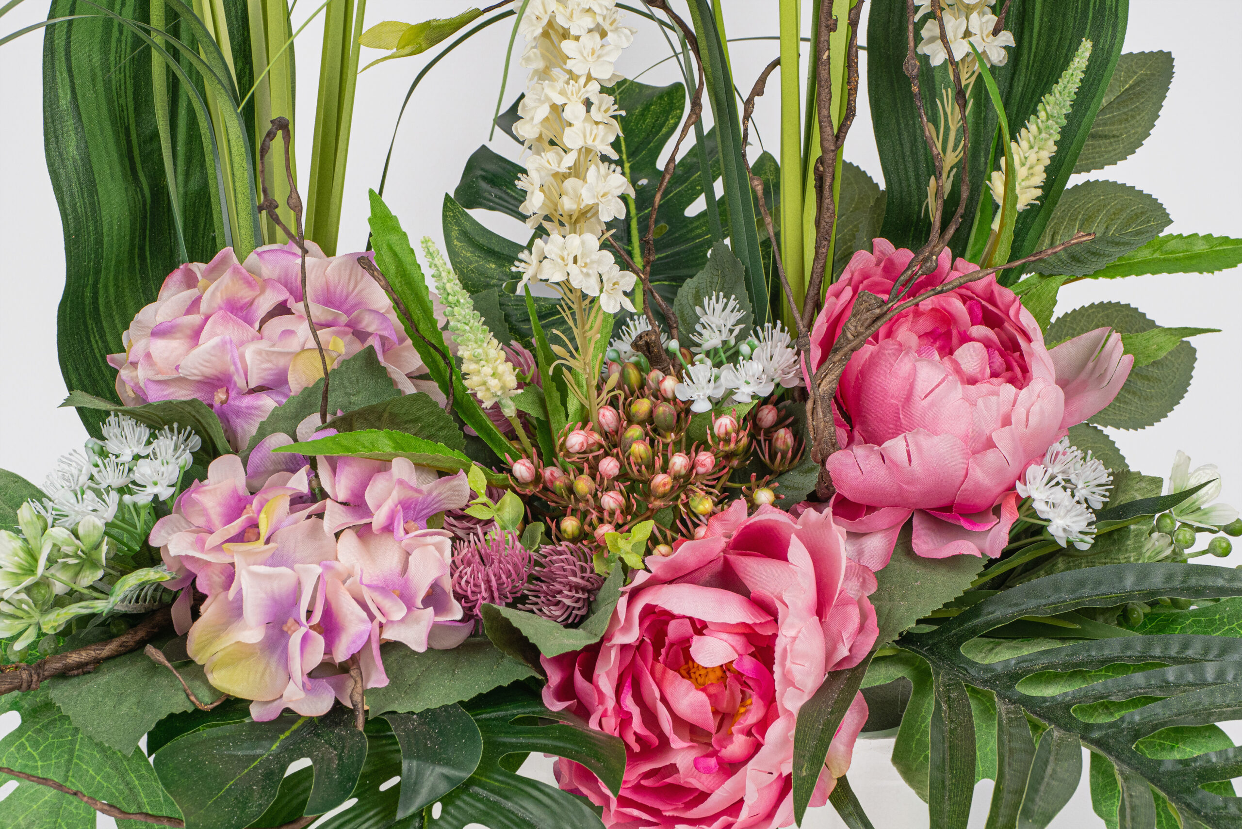 Jardinera artificial de tons rosats.